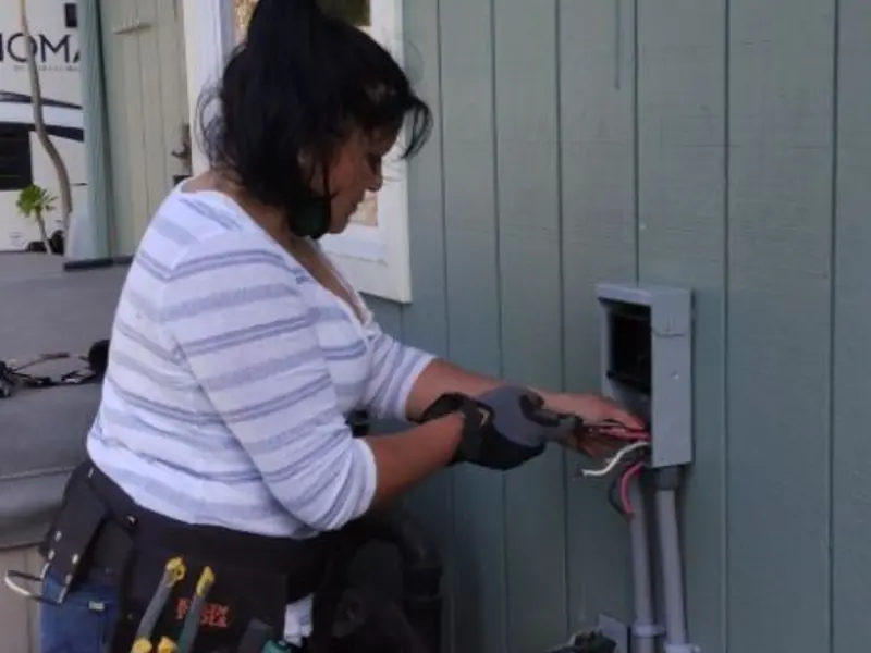 Licensed electrician wiring an exterior subpanel in Poteet